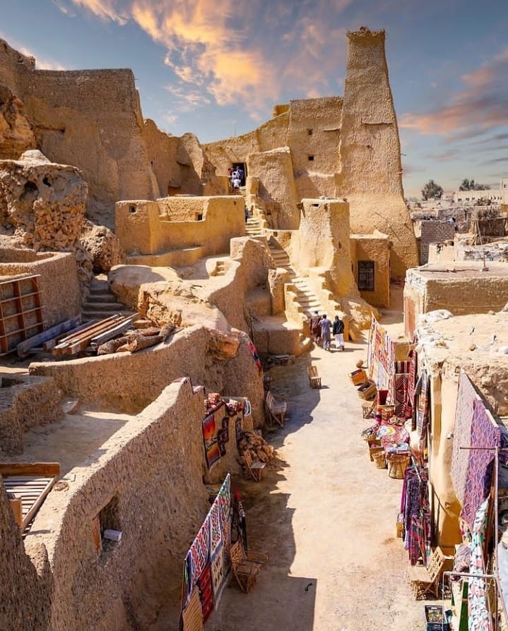 Old market bazaar in Siwa Oasis with colorful textiles and local crafts, Egypt