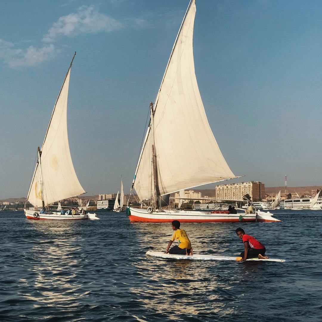 Traditional felucca sailing boats on the Nile River in Aswan, Egypt